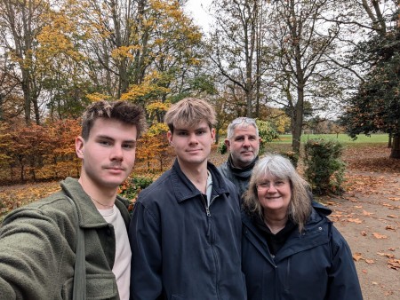 Jack Taylor with his twin brother Max, and their parents Rik and Andrea in a leafy park