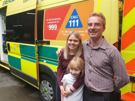 sam with her family in front of the ambulance.jpeg
