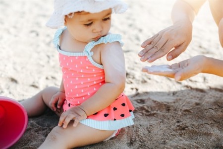 baby sat on a beach