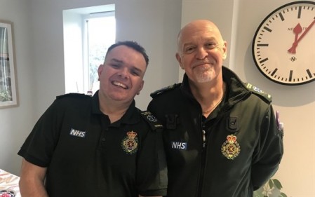 Darren and Michael smiling in green uniform