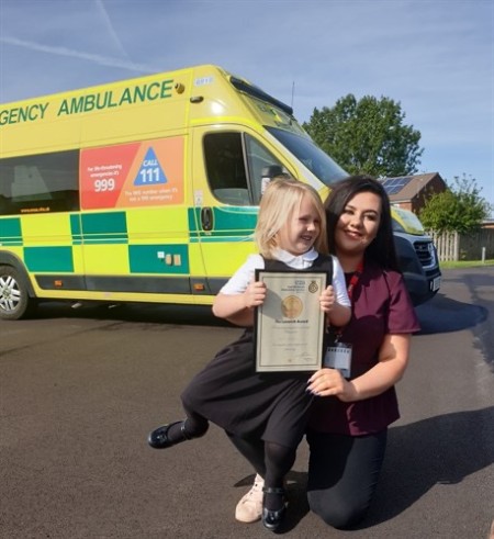 Emily and mum in front of ambulance