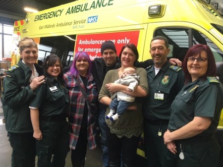 Jack with family and the crew posed in front of an ambulance