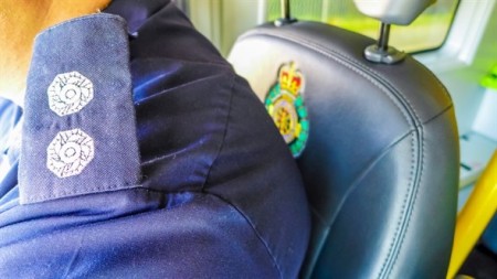 Close shot of shoulder with fire epaulette next to an ambulance crest