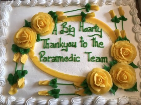 a cake which has written in icing 'a bit hearty thank you to the paramedic team'