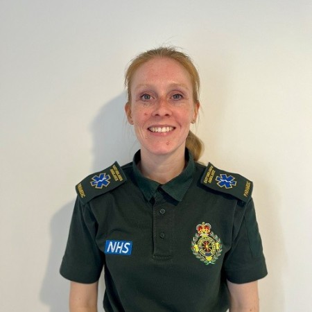 Amy Baggaley pictured in her ambulance uniform. She is stood in front of a plain white background.