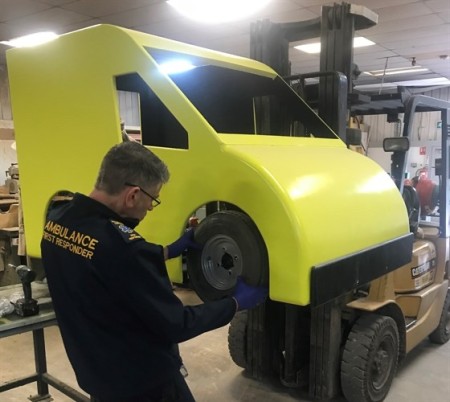 Fitting wheels on to yellow cab 