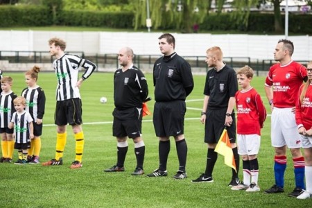 Referees on the pitch at the match last year