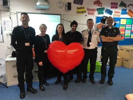 Littleover school emergency services posing with a giant red heart