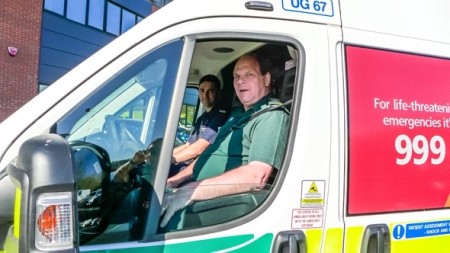 Fire service personnel and ambulance crew member in cab of an urgent care ambulance